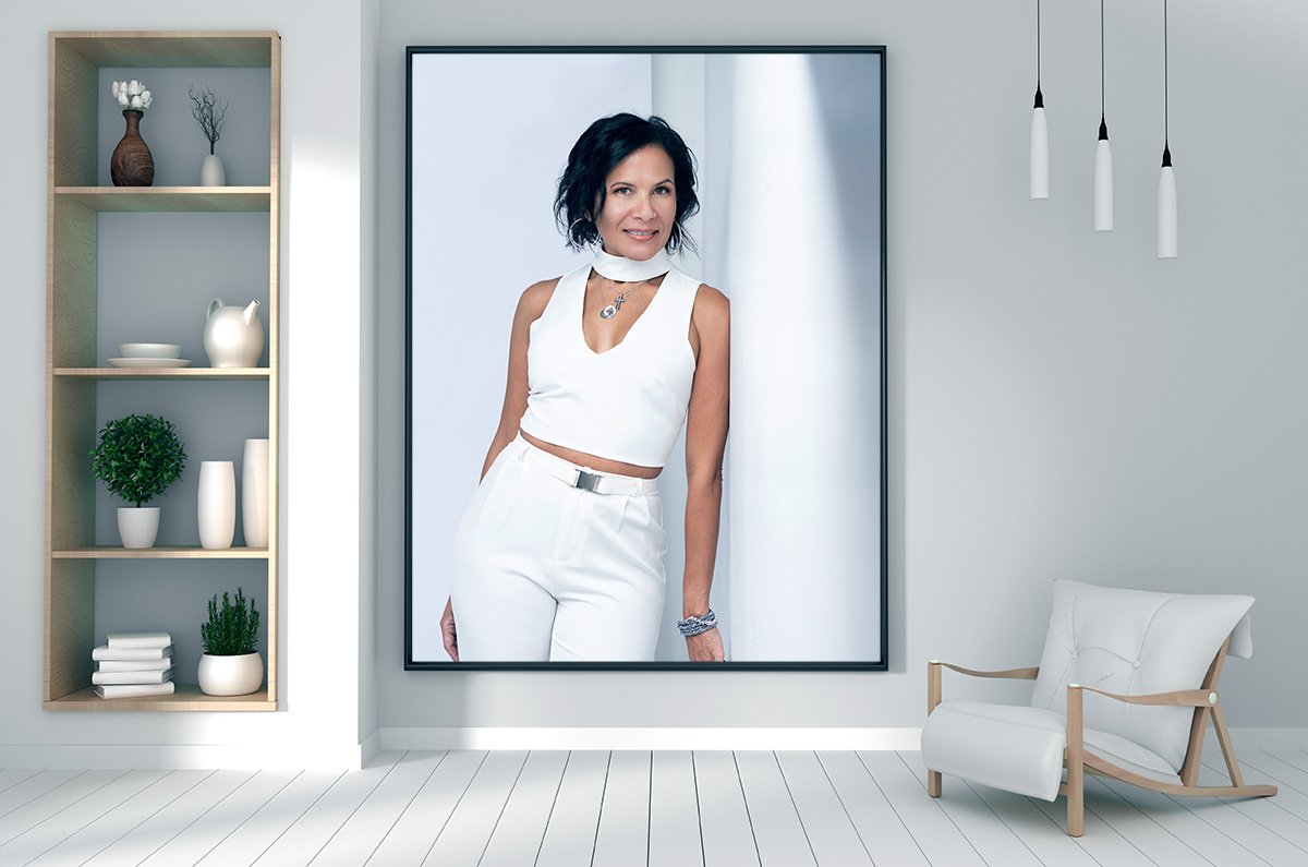 Large framed portrait of a lady dressed in white hanging on a wall